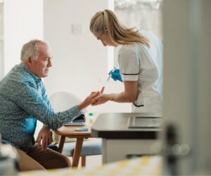 an elderly man is getting his blood sugar tested by a nurse, this test is relevant to diabetes