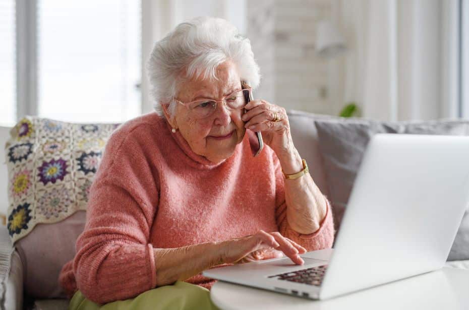 how to avoid holiday scams and fraud senior online older person computer unsure woman research reading