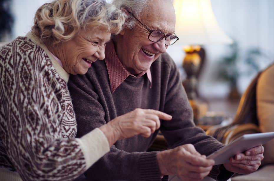 KompleteCare leading the way aged care reform elderly older married couple ipad tablet smile happy